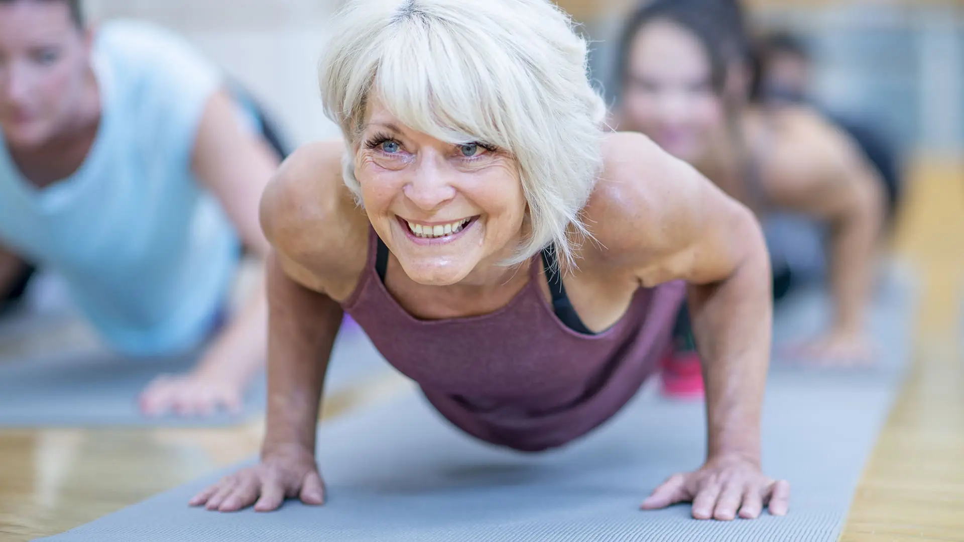 Senior woman does a push up. Senior woman does a push up.