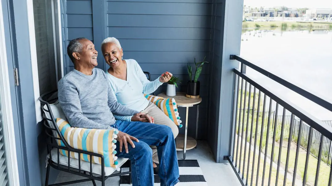 happy-senior-couple-on-balcony